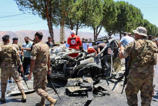 ဇွန် ၂၂ ရက်က လက်ဘနွန်တွင် အစ္စရေး၏ တိုက်ခိုက်မှုကြောင့်  ထိခိုက်ပျက်စီးခဲ့သည့် ဂျမား အစ္စလာမ်မီးယားအဖွဲ့ဝင်တစ်ဦး၏ ကားအနီးတွင် လုံခြုံရေးများကိုတွေ့ရစဉ်