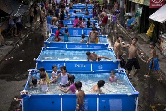 ဖိလစ်ပိုင်နိုင်ငံ မနီလာမြို့တော်တွင် အပူဒဏ်သက်သာစေရန် ဒေသခံအာဏာပိုင်များ၏ အစီအစဉ်ဖြင့် ပြုလုပ်ပေးသည့် ယာယီရေကူးကန်များတွင် ကလေးများရေကစားနေစဉ် (Photo: AFP)
