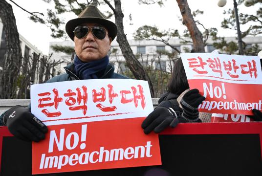 သမ္မတယွန်းဆော့ယိုကို စွပ်စွဲပြစ်တင်ခြင်းမပြုရန် ၎င်းအား ထောက်ခံသူများက ဇန်နဝါရီ ၁၄ ရက်တွင် ဖွဲ့စည်းပုံအခြေခံဥပဒေဆိုင်ရာ ခုံရုံးရှေ့၌ စာတန်းကိုင်၍ဆန္ဒပြနေပုံကို တွေ့ရစဉ်(Photo: AFP)