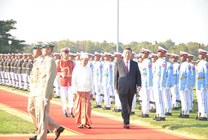 သမ္မတအိမ်တော်မြက်ခင်းပြင်တွင် ပြုလုပ်သည့် ဂုဏ်ပြုကြိုဆိုခြင်းအခမ်းအနား၌ ဂုဏ်ပြုတပ်ဖွဲ့အား လိုက်လံစစ်ဆေးနေသည့် နိုင်ငံတော်သမ္မတ ဦးဝင်းမြင့်နှင့် တရုတ်သမ္မတ ရှီကျင်ပင်း